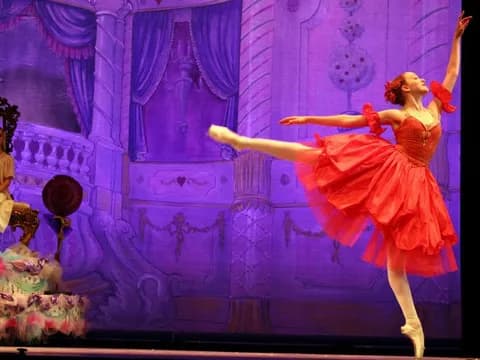 Performing on stage in a red ballet costume